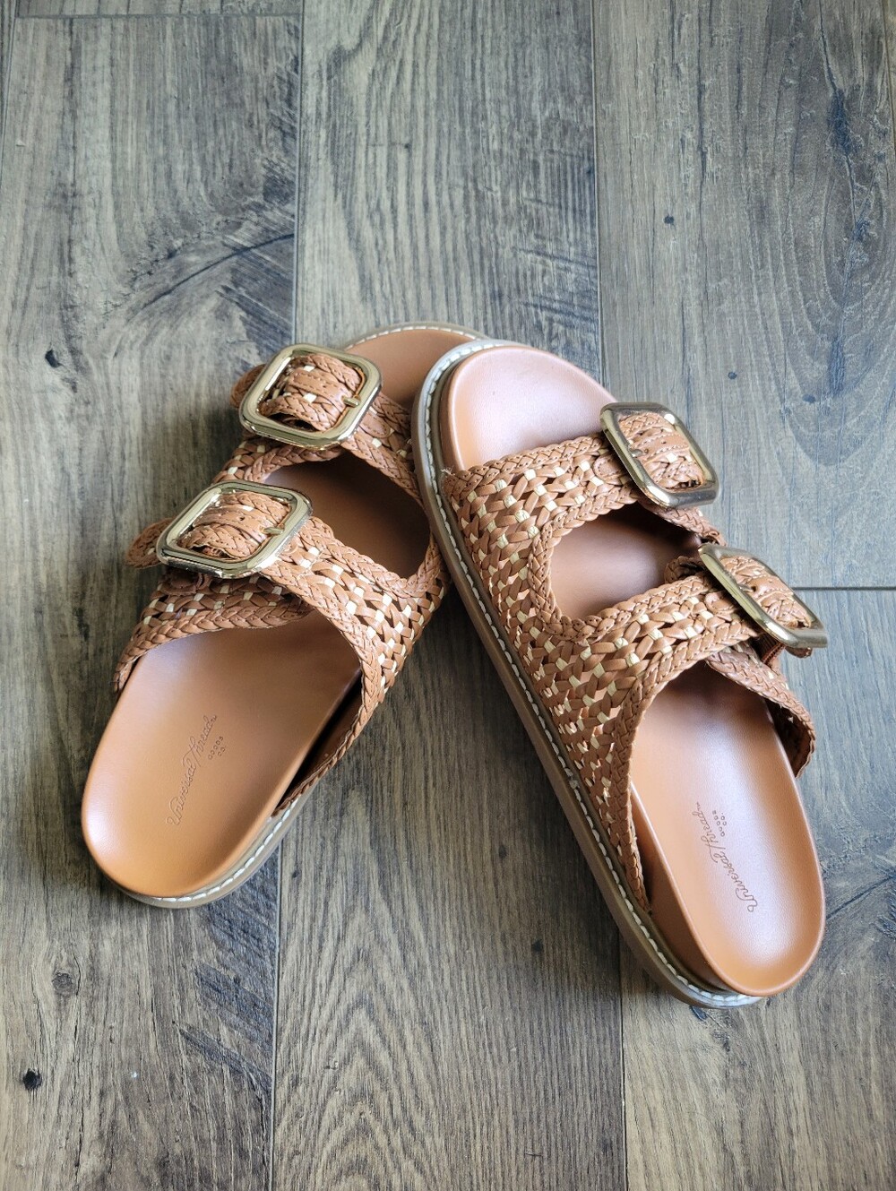 Brown slide on sandals with adjustable buckles